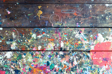 artists workshop or studio bench covered with splattered paint built up in authentic texture on pain