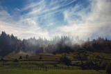 Fototapeta Na ścianę - Mountain landscape with smoke on a beautiful sunny day