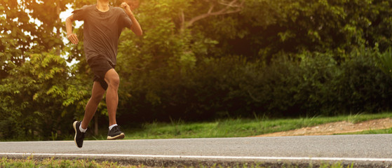 Wall Mural - Young black runner man running on the street be exercise and workout in nature countryside road in the morning. Healthy body exercise sports concept. for banner website