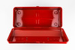 Empty classic vintage style red metal toolbox shot from above with a hinged lid in a white studio.