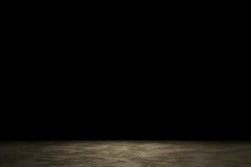 Light shining down on brown sand floor in dark room with copy space, abstract background