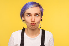 Portrait Of Comic Hipster Girl With Violet Short Hair Looking Cross Eyed, Making Silly Awkward Face Expression, Having Fun And Playing Fool. Isolated On Yellow Background, Indoor Studio Shot, Closeup