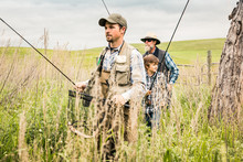 Grandfather, Father And Grandson Walking To Stream To Go Flyfishing. Red Lodge, Montana, USA