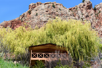 Wooden garden house for relaxation under rock near Noravank Monastery, Armenia