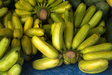 clusters of bananas are on the market counter, a healthy fruit with potassium content