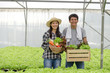 © Vittaya_25 - asian young friendly couple farmer smiling and holding organic hydroponic fresh green vegetables produce wooden box together in greenhouse garden nursery farm, business farmer and healthy food concept