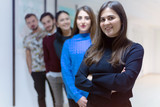 Fototapeta  - Business, education and sucess concept, Group of Young business people standing and looking at camera.