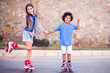 © Aleksej - Two happy kids boy and girl roller skate in the park. Children and activity concept