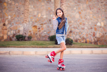 Smiling Kid Girl Roller Skate In The Park. Children And Activity Concept