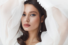 Portrait Of Elegant Beautiful Bride Wearing Fashion Wedding Dress. Perfect Makeup And Hairstyle