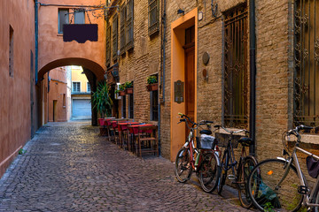 Wall Mural - Cozy narrow street in Ferrara, Emilia-Romagna, Italy. Ferrara is capital of the Province of Ferrara