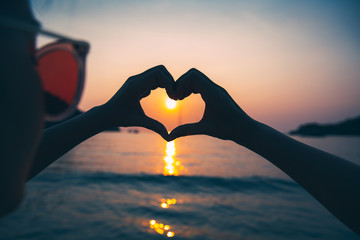 Wall Mural - Female hand in heart shape
