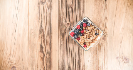 Wall Mural - Breakfast of granola and wild berries. Delivered in a glass plate