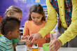 © DenisProduction.com - Kids doing a chemical experiment in playroom. Kids having fun at childrens entertainment center. Easy science experiments for kids.