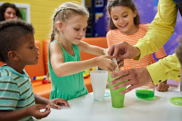 Kids doing chemical experiment at Birthday party. Colorful chemical reaction experiments for kids. Kids party entertainment ideas.