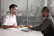 © fizkes - Motivated male applicant talk with recruiter at interview