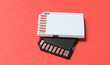 Two Mini SD memory cards on pink background close up