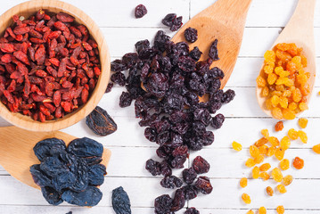 Canvas Print - dried goji, cherry, raisin and plum fruits on white wood