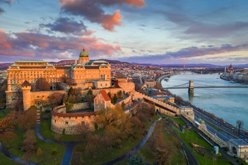 Wall Mural - Budapest, Hungary - Golden sunrise at Buda Castle Royal Palace with Szechenyi Chain Bridge, Parliament and colorful clouds