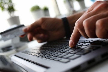 male arms hold credit card press buttons making transfer closeup. anti-fraud financial security when