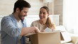 © fizkes - Happy young couple unpack box shopping online