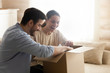 © fizkes - Overjoyed young couple open package shopping online