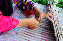 A Woman Is Using Traditional Weaving Machines To Weave Songket. Songket Is A Malay Traditional Clothes With High Quality And Valuable.
