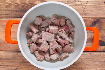 Step by step cooking of khashlama with beef and vegetables, step 2 - chopped beef in a pan, top view