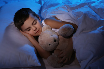 Wall Mural - Little boy sleeping with teddy bear at home. Bedtime