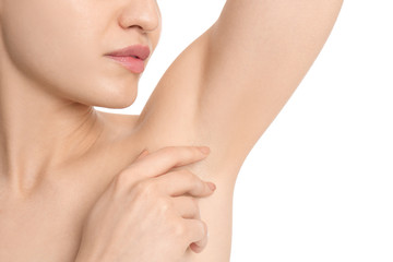 Young woman showing armpit with smooth clean skin on white background, closeup