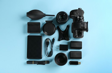 Wall Mural - flat lay composition with camera and video production equipment on light blue background