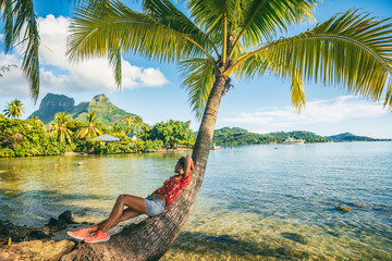 tropical travel nature background tourist woman on eco tourism destination relaxing lying down on pa