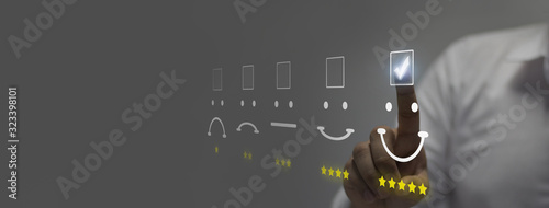 Fotografía Businessman pressing smiley face emoticon on virtual touch screen