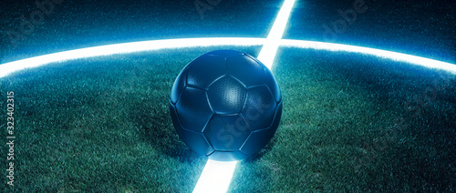 Fotografía Soccer ball on glowing lines on a field at night