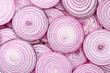 © Nikolay - Onion slices as a background. Top view.