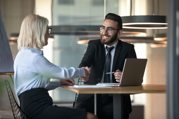 Poster - Middle eastern ethnicity HR manager hiring elderly woman people handshaking