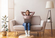 © Prostock-studio - Young woman relaxing with laptop at home interior