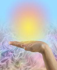 Wall Mural - Focusing and Sending Golden Healing Energy - female open palm with a vivid yellow orange orb of energy against a blue graduated to energy flowing background with copy space
