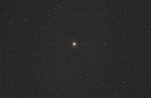 Closeup Of Betelgeuse Star Or Alpha Orionis In Orion Constellation, With Many Stars As Background In The Deep Space.