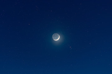 waxing crescent moon, earthshine and starry night sky