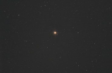 Wall Mural - closeup of betelgeuse star or alpha orionis in orion constellation, with many stars as background in
