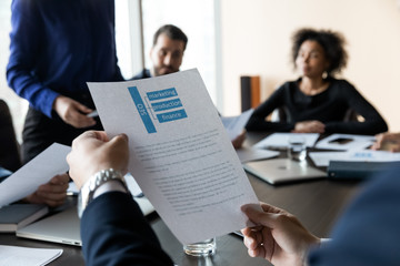 Close up businessman hands holding document of seo structure.