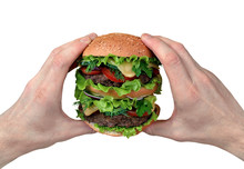 Big Hamburger In The Hands Of A Man On An Isolated White Background.