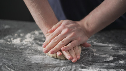 Wall Mural - man working with dough on concrete countertop