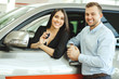 © Roman - new owners of automobile, caucasian married couple posing in dealership, in car showroom. people, emotions concept. transport, vehicle concept