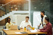 © the faces - young handsome man checking documents, consulting his colleagues during the meeting. close up photo, teamwork, friendship, companionship