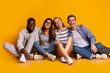 © Prostock-studio - Happy students posing over yellow studio background
