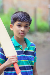 Wall Mural - Portrait of Indian boy playing cricket