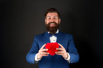 Best wishes from sincere heart. Businessman in bow tie. Heart symbol aesthetics. Valentines day holiday. Love and relations. Wedding day. Bearded man groom in formal suit. Health care. Heart in hands