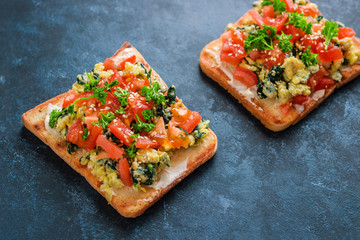 Wall Mural - healthy sandwiches with diced tomatoes cream cheese spinach scrambled egg sesame seeds parsley